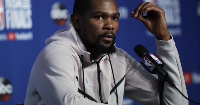 Kevin Durant was held back from a Cavs fan outside the team hotel