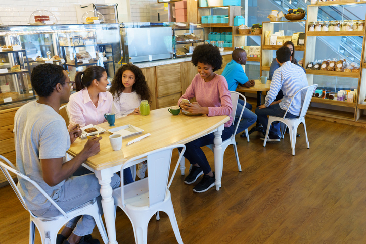 Happy family having a cup of coffee at a cafe